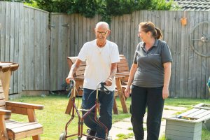 Carer and Resident enjoying care home, garden photography